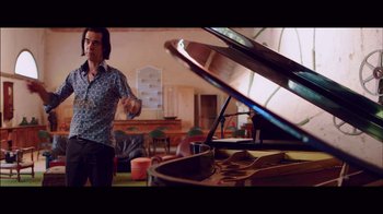 Movie still from “20,000 Days on Earth” (2014), directed by Iain Forsyth – A man standing in front of an open grand piano; Medium shot, Over the shoulder angle