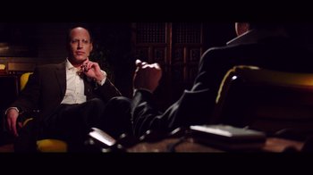 Movie still from “20,000 Days on Earth” (2014), directed by Iain Forsyth – A man sitting in front of another man in a suit; Medium shot, Over the shoulder angle