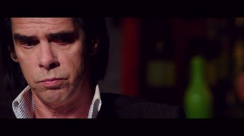 Movie still from “20,000 Days on Earth” (2014), directed by Iain Forsyth – A person wearing a suit and tie; Close Up shot, Low angle