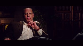 Movie still from “20,000 Days on Earth” (2014), directed by Iain Forsyth – A man sitting in a chair with his hand under his chin; Close Up shot, Over the shoulder angle