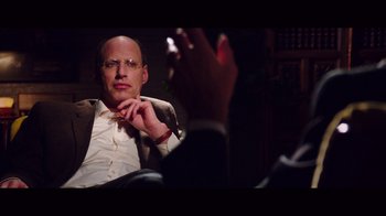 Movie still from “20,000 Days on Earth” (2014), directed by Iain Forsyth – A man sitting in front of another man holding a cigarette; Close Up shot, Over the shoulder angle