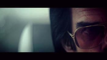 Movie still from “20,000 Days on Earth” (2014), directed by Iain Forsyth – A person's face wearing glasses; Extreme Close Up shot, Low angle