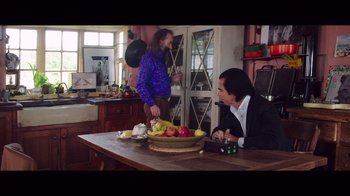 Movie still from “20,000 Days on Earth” (2014), directed by Iain Forsyth – A man sitting at a table in front of a bowl of fruit; Medium shot, Low angle