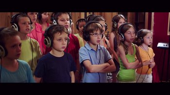 Movie still from “20,000 Days on Earth” (2014), directed by Iain Forsyth – A group of children wearing headphones and listening to music; Close Up shot, High angle