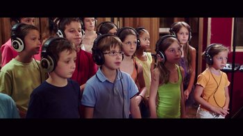 Movie still from “20,000 Days on Earth” (2014), directed by Iain Forsyth – A group of children wearing headphones in a room; Close Up shot, High angle