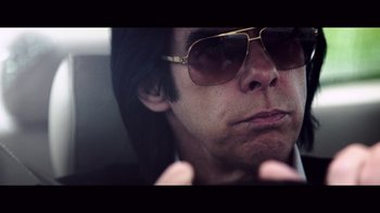 Movie still from “20,000 Days on Earth” (2014), directed by Iain Forsyth – A person wearing sunglasses; Extreme Close Up shot, Low angle