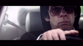Movie still from “20,000 Days on Earth” (2014), directed by Iain Forsyth – A man wearing sunglasses and sitting in a car; Close Up shot, Low angle