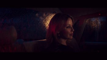 Movie still from “20,000 Days on Earth” (2014), directed by Iain Forsyth – A woman sitting in the back seat of a car at night; Close Up shot, Over the shoulder angle