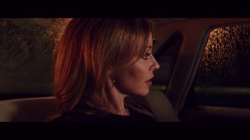 Movie still from “20,000 Days on Earth” (2014), directed by Iain Forsyth – A woman sitting in the back seat of a car; Close Up shot, Over the shoulder angle