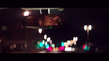 Movie still from “20,000 Days on Earth” (2014), directed by Iain Forsyth – A man looking into a rear view mirror of a car; Close Up shot, Low angle