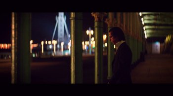Movie still from “20,000 Days on Earth” (2014), directed by Iain Forsyth – A man standing next to a pole at night; Wide shot, Low angle