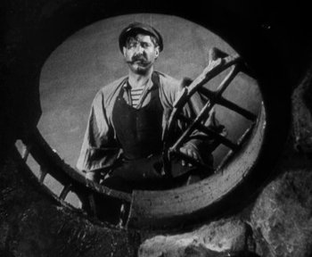 Movie still from “7th Heaven” (1927), directed by Frank Borzage – A man in an old photo looking at the camera; Medium shot, High angle