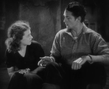 Movie still from “7th Heaven” (1927), directed by Frank Borzage – A man and a woman sitting on a couch talking; Medium shot, High angle