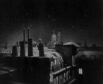 Movie still from “7th Heaven” (1927), directed by Frank Borzage – A black - and - white photo of a city at night; Extreme Wide shot, High angle