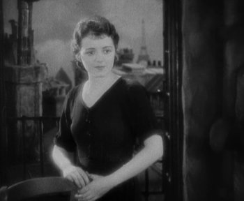 Movie still from “7th Heaven” (1927), directed by Frank Borzage – A woman standing on a balcony in front of the eiffel tower; Medium shot, High angle