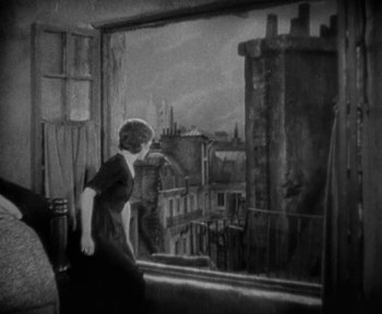 Movie still from “7th Heaven” (1927), directed by Frank Borzage – A woman standing in front of an open window; Wide shot, High angle
