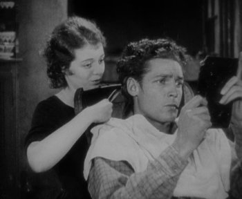 Movie still from “7th Heaven” (1927), directed by Frank Borzage – An old photo of a man getting his hair cut; Medium shot, Low angle
