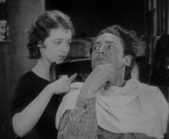 Movie still from “7th Heaven” (1927), directed by Frank Borzage – An old photo of a man getting his hair cut; Close Up shot, Low angle