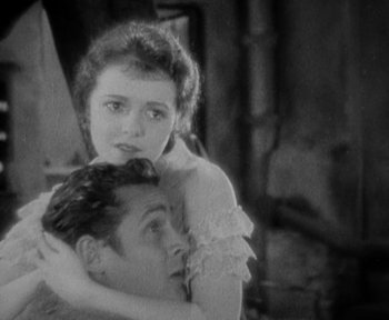 Movie still from “7th Heaven” (1927), directed by Frank Borzage – An old photo of a man and a woman hugging; Close Up shot, High angle