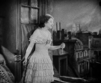 Movie still from “7th Heaven” (1927), directed by Frank Borzage – An old photo of a woman standing on a balcony; Medium shot, High angle