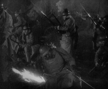 Movie still from “7th Heaven” (1927), directed by Frank Borzage – A black and white photo of a group of people holding sticks; Wide shot, High angle