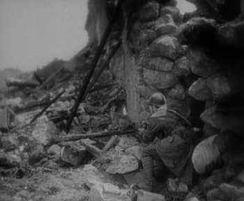 Movie still from “7th Heaven” (1927), directed by Frank Borzage – An old photo of a man sitting in the ruins of a building; Wide shot, High angle