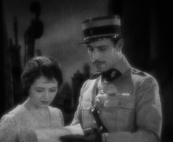 Movie still from “7th Heaven” (1927), directed by Frank Borzage – A man and a woman looking at each other in a black and white photo; Medium shot, High angle