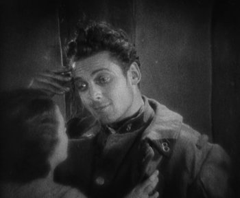 Movie still from “7th Heaven” (1927), directed by Frank Borzage – A black and white photo of a man looking in a mirror; Close Up shot, High angle