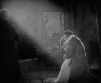 Movie still from “7th Heaven” (1927), directed by Frank Borzage – A man and a woman sitting on the ground in front of a mirror; Wide shot, High angle