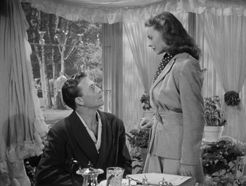 Movie still from “A Letter to Three Wives” (1949), directed by Joseph L. Mankiewicz – A man and a woman are sitting at a dining table; Medium shot, Low angle