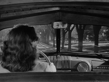 Movie still from “A Letter to Three Wives” (1949), directed by Joseph L. Mankiewicz – A black and white photo of a woman driving a car; Medium shot, Over the shoulder angle