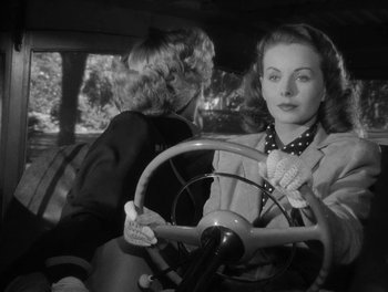 Movie still from “A Letter to Three Wives” (1949), directed by Joseph L. Mankiewicz – A woman sitting in the driver's seat of a car; Close Up shot, Over the shoulder angle
