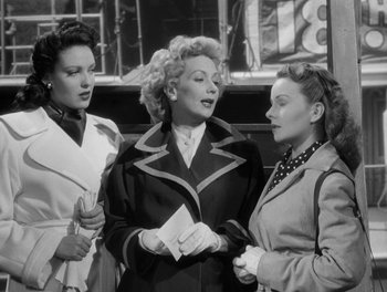 Movie still from “A Letter to Three Wives” (1949), directed by Joseph L. Mankiewicz – A group of women standing next to each other on a street; Medium shot, Low angle