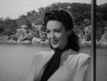 Movie still from “A Letter to Three Wives” (1949), directed by Joseph L. Mankiewicz – A black - and - white photo of a woman in a black tie; Close Up shot, Low angle