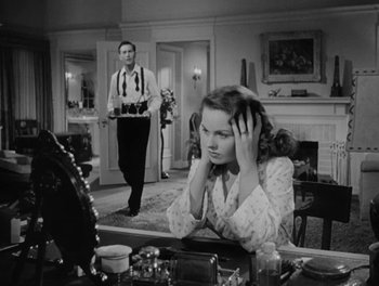 Movie still from “A Letter to Three Wives” (1949), directed by Joseph L. Mankiewicz – A man and a woman in a living room; Medium shot, Over the shoulder angle