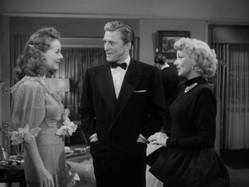 Movie still from “A Letter to Three Wives” (1949), directed by Joseph L. Mankiewicz – Two women and a man standing next to each other in a room; Medium shot, Over the shoulder angle