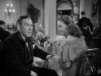 Movie still from “A Letter to Three Wives” (1949), directed by Joseph L. Mankiewicz – A man and a woman sitting at a table in a restaurant; Medium shot, Over the shoulder angle