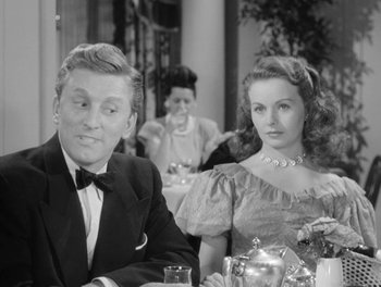 Movie still from “A Letter to Three Wives” (1949), directed by Joseph L. Mankiewicz – A man and a woman sitting at a dinner table; Medium shot, Over the shoulder angle