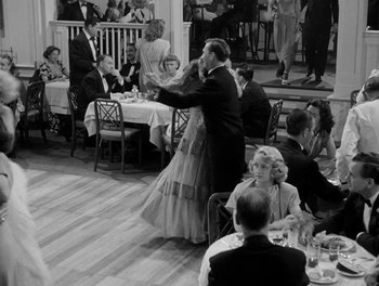 Movie still from “A Letter to Three Wives” (1949), directed by Joseph L. Mankiewicz – A man and a woman dancing in front of a crowd of diners; Wide shot, High angle