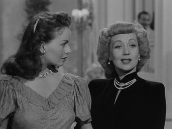 Movie still from “A Letter to Three Wives” (1949), directed by Joseph L. Mankiewicz – Two women standing next to each other in front of a mirror; Close Up shot, Over the shoulder angle
