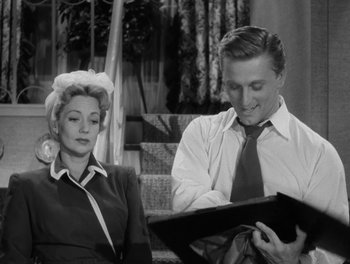 Movie still from “A Letter to Three Wives” (1949), directed by Joseph L. Mankiewicz – A man and a woman looking at a piece of paper; Medium shot, Over the shoulder angle