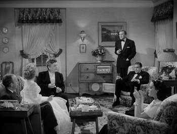 Movie still from “A Letter to Three Wives” (1949), directed by Joseph L. Mankiewicz – A group of people sitting around a living room; Wide shot, High angle