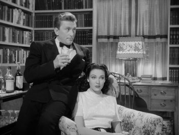 Movie still from “A Letter to Three Wives” (1949), directed by Joseph L. Mankiewicz – A man and a woman sitting on a couch; Medium shot, Low angle