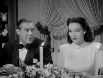 Movie still from “A Letter to Three Wives” (1949), directed by Joseph L. Mankiewicz – A man and a woman sitting at a dinner table; Medium shot, Over the shoulder angle