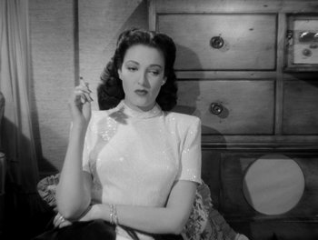 Movie still from “A Letter to Three Wives” (1949), directed by Joseph L. Mankiewicz – An old photo of a woman smoking a cigarette; Medium shot, Low angle
