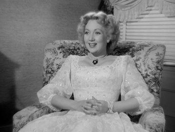Movie still from “A Letter to Three Wives” (1949), directed by Joseph L. Mankiewicz – An old photo of a woman sitting in a chair; Medium shot, High angle