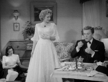 Movie still from “A Letter to Three Wives” (1949), directed by Joseph L. Mankiewicz – A man and a woman are sitting at a dinner table; Medium shot, Low angle
