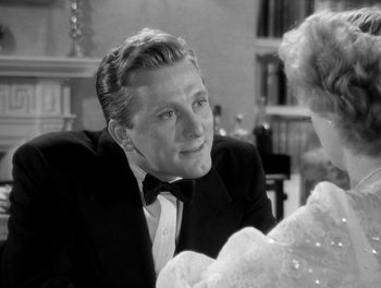 Movie still from “A Letter to Three Wives” (1949), directed by Joseph L. Mankiewicz – A black and white photo of a man in a tuxedo; Close Up shot, Over the shoulder angle