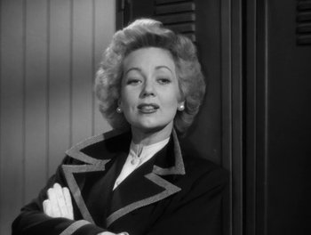 Movie still from “A Letter to Three Wives” (1949), directed by Joseph L. Mankiewicz – An old photo of a woman in a black suit; Medium shot, Low angle