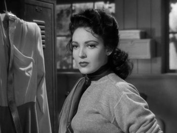 Movie still from “A Letter to Three Wives” (1949), directed by Joseph L. Mankiewicz – A black - and - white photo of a woman in a sweater; Close Up shot, Over the shoulder angle
